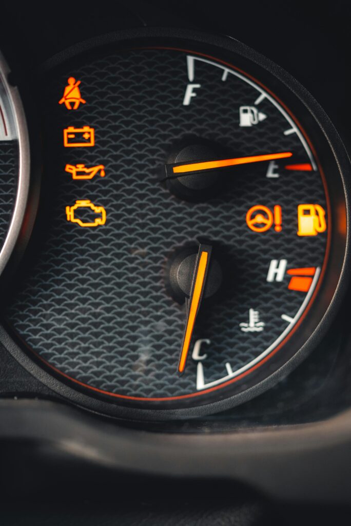 Detailed close-up of car dashboard with various warning lights illuminated.